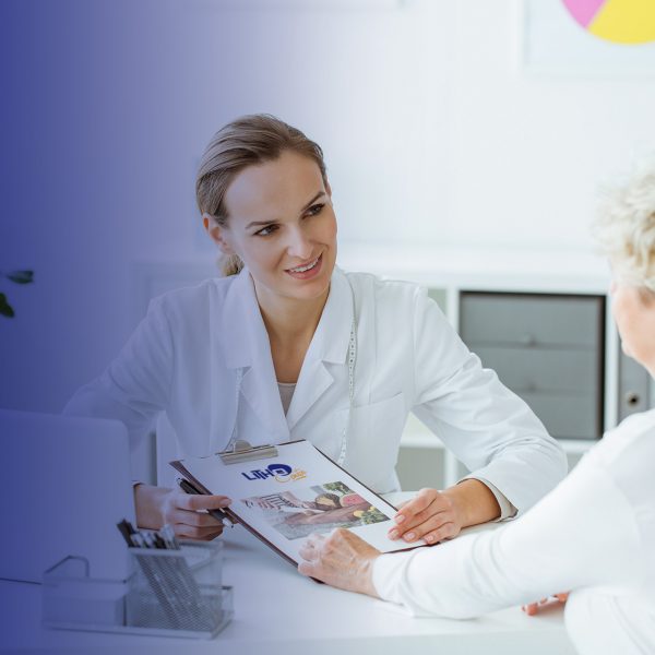 Smiling dietitian holding diet plan during consultation with patient in the office with laptop on desk